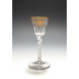 A small Giles-decorated wine glass, c.1765, the rounded funnel bowl moulded with vertical flutes,