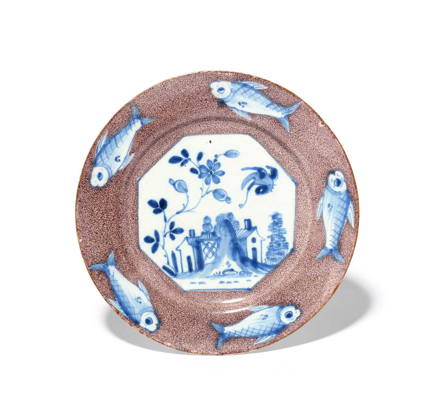 A delftware plate, c.1750, the well painted in blue with an octagonal panel depicting a bird in