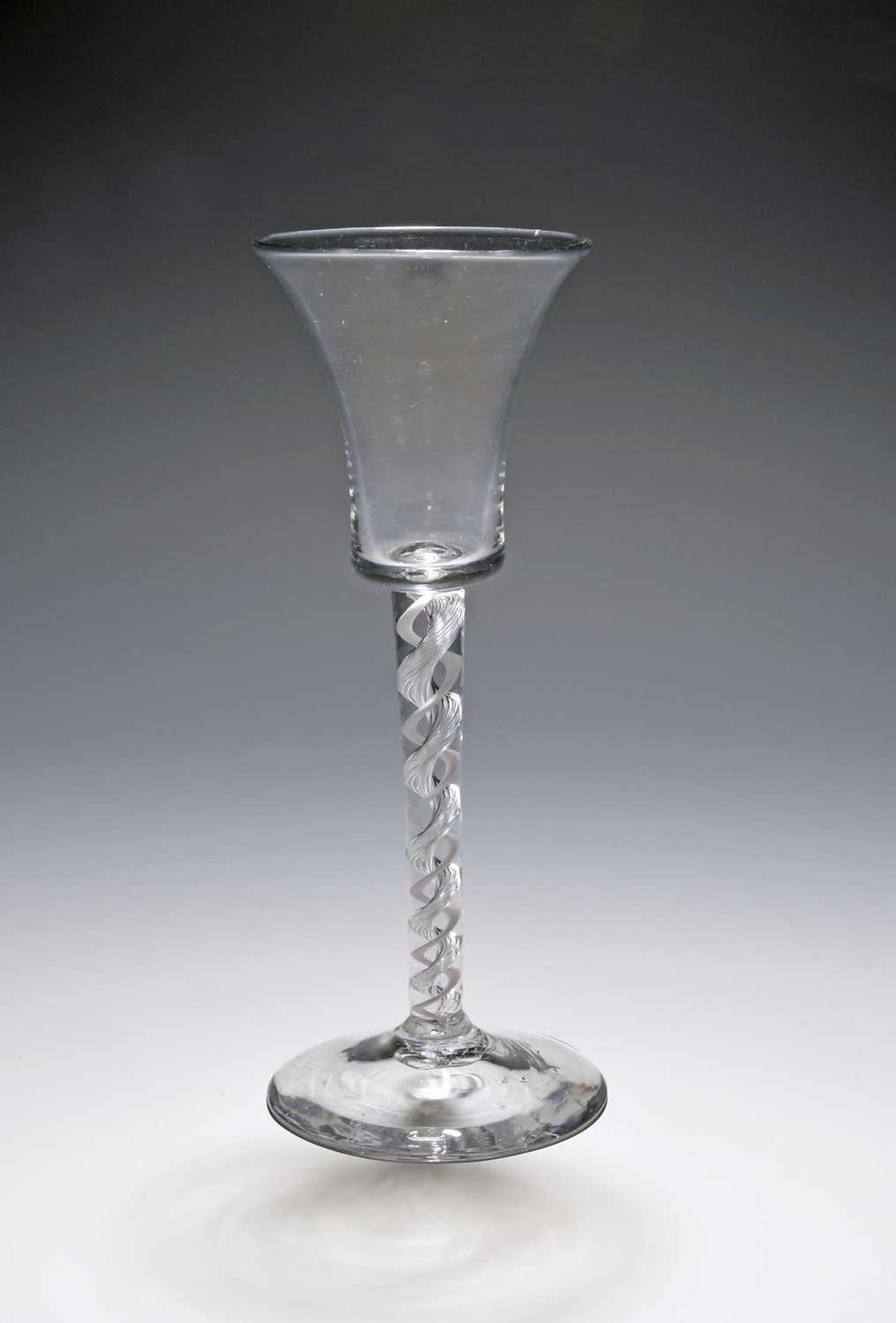 A mixed twist wine glass, c.1760, the slender flared bucket bowl raised on a mixed twist stem with a