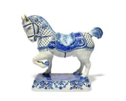 A Delft figure of a horse, late 18th century, modelled with ears pricked and left fore hoof