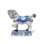 A Delft figure of a horse, late 18th century, modelled with ears pricked and left fore hoof