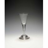 A wine glass, c.1720-30, the drawn trumpet bowl raised on a plain stem enclosing a long tear over