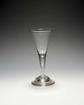 A wine glass, c.1720-30, the drawn trumpet bowl raised on a plain stem enclosing a long tear over