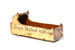 A slipware model of a cradle, dated 1815, one side incised 'Sarah Pattrick Westbridge 1815' on a