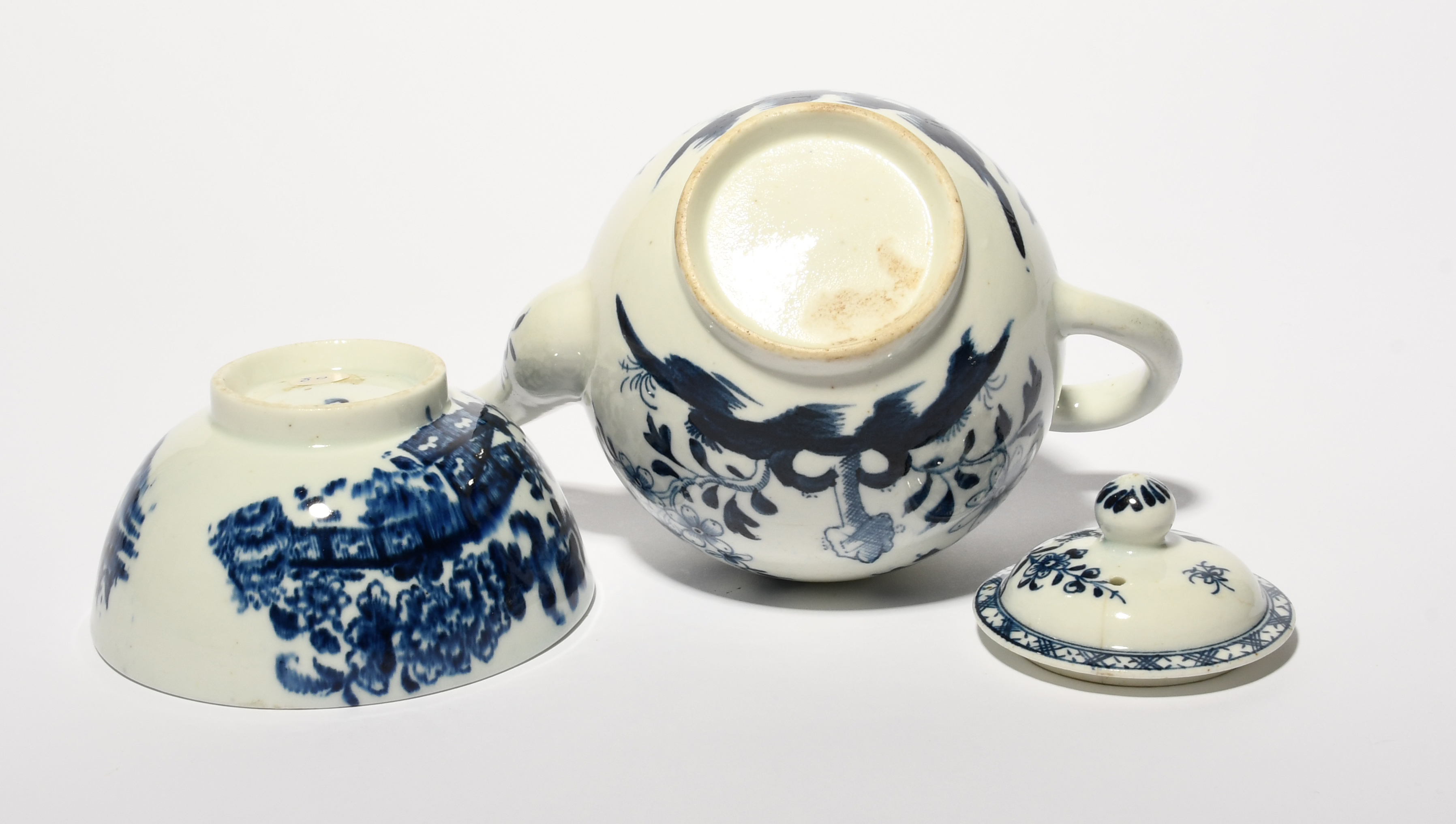 A Lowestoft blue and white teapot and cover, c. 1765-70, painted with flowers emerging from holey - Image 3 of 3