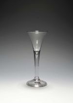 A small wine glass, c.1730, the drawn trumpet bowl raised on a slender plain stem enclosing a single