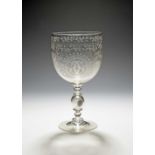 A large glass coin goblet, c.1860, the deep cup bowl engraved with a monogram 'CC' in a circular