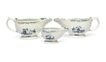 A pair of large Lowestoft blue and white sauceboats, c.1765-70, of Hughes type, moulded with