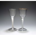 Two wine glasses, c.1760, one with ogee bowl and traces of a gilt rim, the other a round funnel