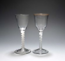 Two wine glasses, c.1760, one with ogee bowl and traces of a gilt rim, the other a round funnel