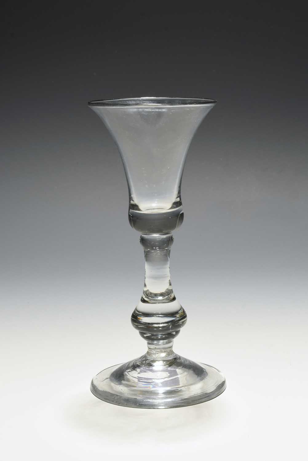 A baluster wine glass, c.1720, the bell bowl with a solid base, raised above a drop knop stem and
