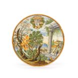 A Castelli maiolica armorial plate, 1st half 18th century, painted in typical palette of green,