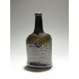 A sealed wine bottle, dated 1767, the squat mallet form applied with a circular seal bearing the
