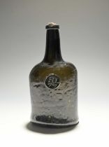 A sealed wine bottle, dated 1767, the squat mallet form applied with a circular seal bearing the