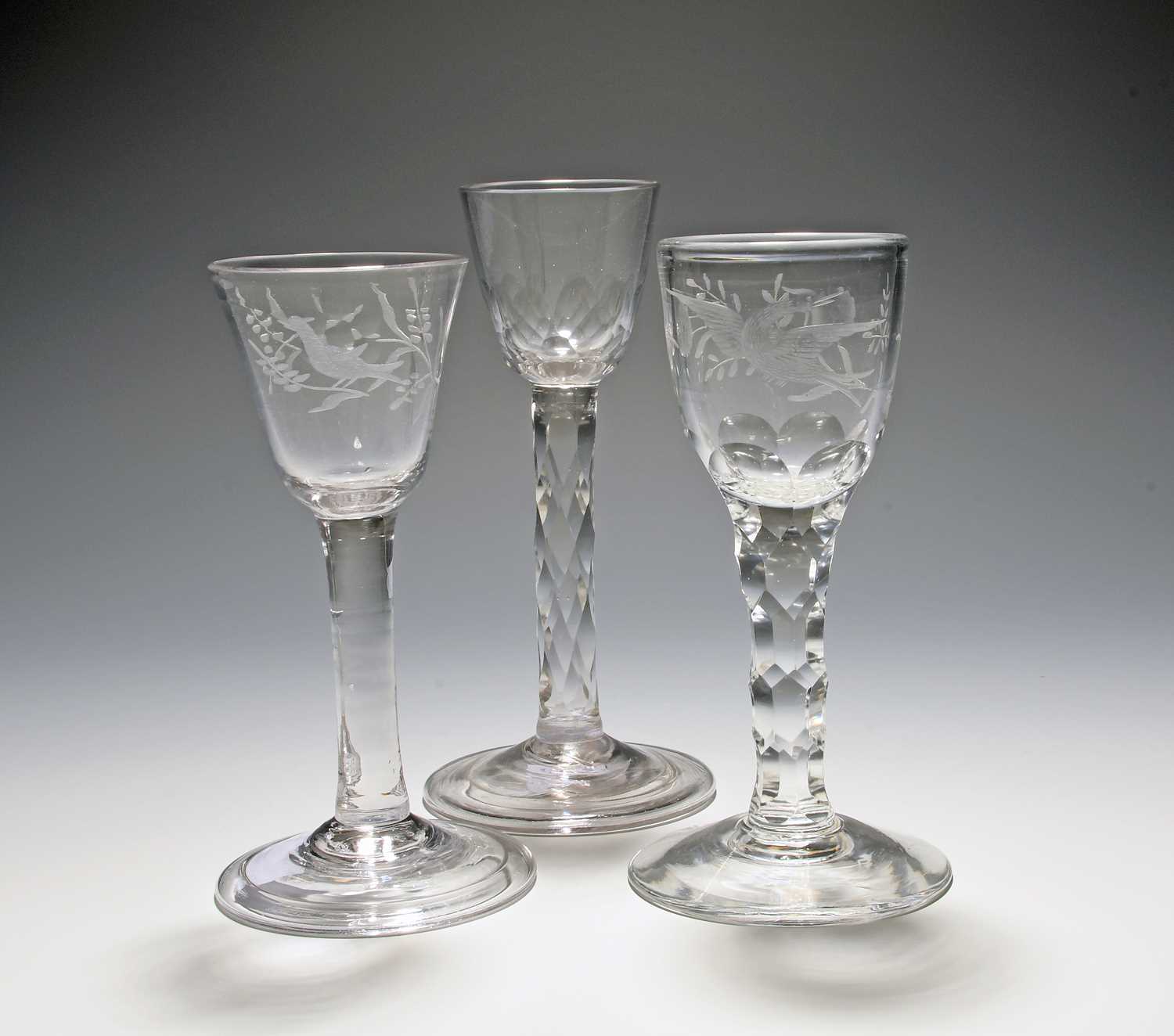 Three small wine glasses, c.1760, two of possible Jacobite significance, engraved with a bird and