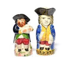 A Yorkshire standing toby jug, c.1810-20, holding a glass and bottle, wearing a sponged blue coat