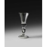 A large and rare baluster wine glass or goblet, c.1710, the thistle bowl with a solid base, raised