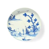 A rare Vauxhall blue and white saucer dish, c.1755, painted with a Chinese figure standing beneath a