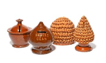Four small Sussex slipware money boxes, 19th century, two modelled as pinecones with alternating