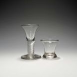 Two dram or firing glasses, 2nd half 18th century, one with a drawn trumpet bowl over a thick