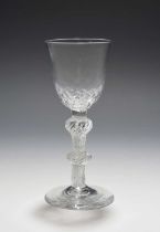 A wine glass, c.1760, the rounded funnel bowl with honeycomb moulding, raised on a double knopped