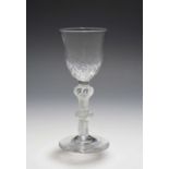 A wine glass, c.1760, the rounded funnel bowl with honeycomb moulding, raised on a double knopped