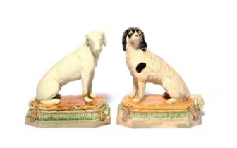 A pair of Wood type pearlware figures of dogs, c.1785-95, modelled as a spaniel and a pointer seated