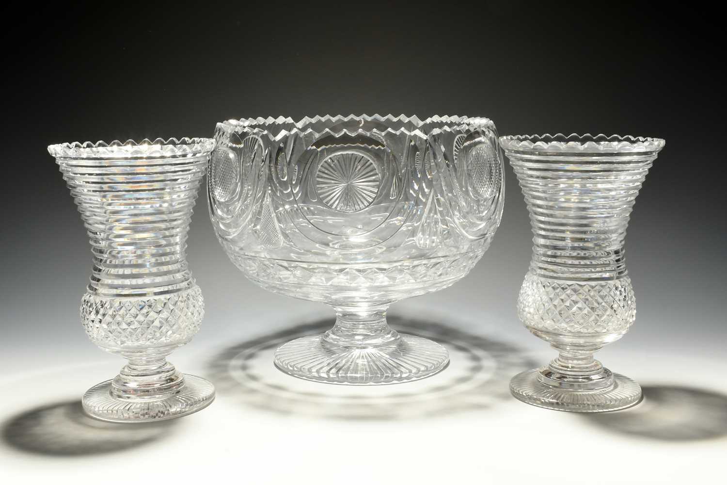 A large cut glass punchbowl, 19th century, cut with star and diamond roundels between swags, and a