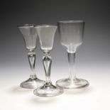 A pair of small wine or cordial glasses, c.1740, the bell bowls raised on balustroid stems enclosing