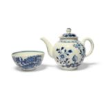 A Lowestoft blue and white teapot and cover, c. 1765-70, painted with flowers emerging from holey