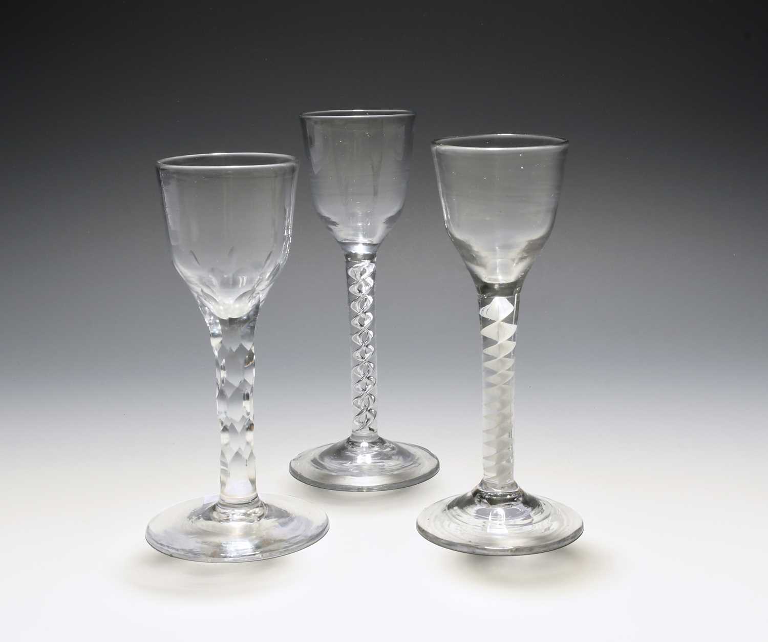 Three small wine glasses, c.1760, with ogee bowls raised on varying stems, one with a mercury twist,