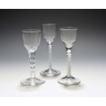 Three small wine glasses, c.1760, with ogee bowls raised on varying stems, one with a mercury twist,
