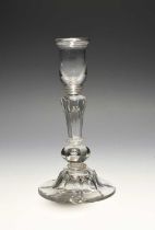 A composite stem glass candlestick, c.1740, the U-shaped sconce raised on an inverted Silesian