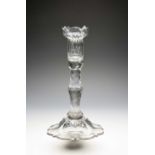 An unusual cut and moulded glass candlestick, late 18th century, the sconce moulded with vertical