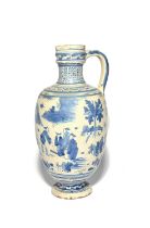 A large and early Delft jug or ewer, c.1660, painted in a bright blue with clusters of Chinese