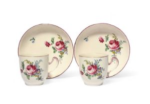 A pair of Tournai coffee cups and saucers, c.1760-70, painted with sprays of flowers including