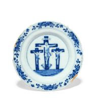 A Delft Crucifixion plate, mid 18th century, painted in blue with Christ on the cross between the