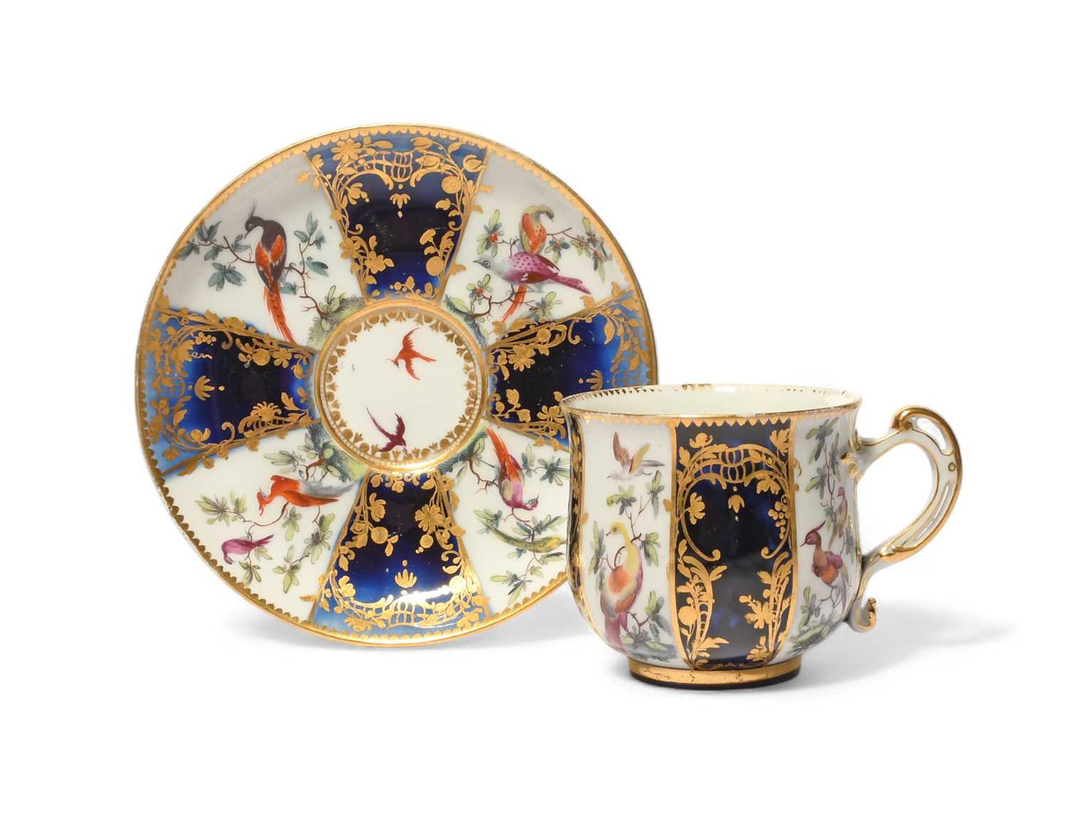 A Chelsea cabinet cup and saucer, c.1760-65, finely decorated with panels of colourful birds perched