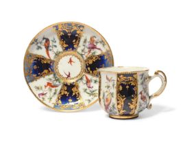 A Chelsea cabinet cup and saucer, c.1760-65, finely decorated with panels of colourful birds perched