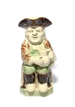 A creamware Wood type Toby jug, c.1790, seated with a foaming jug of ale, his waistcoat and breeches
