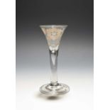 A Jacobite wine glass, c.1750, the drawn trumpet bowl engraved with a large rose and bud spray