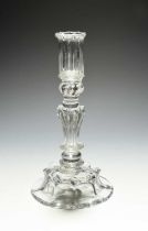 A moulded glass candlestick, c.1720, the tall sconce moulded with vertical flutes, above a beaded
