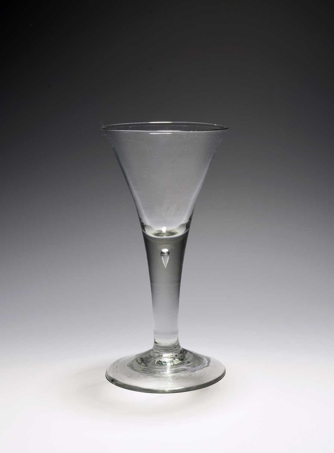 A large wine glass or goblet, c.1740-50, the generous drawn trumpet bowl rising from a plain stem