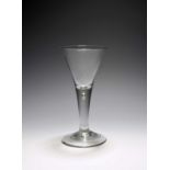 A large wine glass or goblet, c.1740-50, the generous drawn trumpet bowl rising from a plain stem