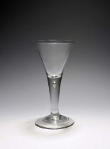 A large wine glass or goblet, c.1740-50, the generous drawn trumpet bowl rising from a plain stem
