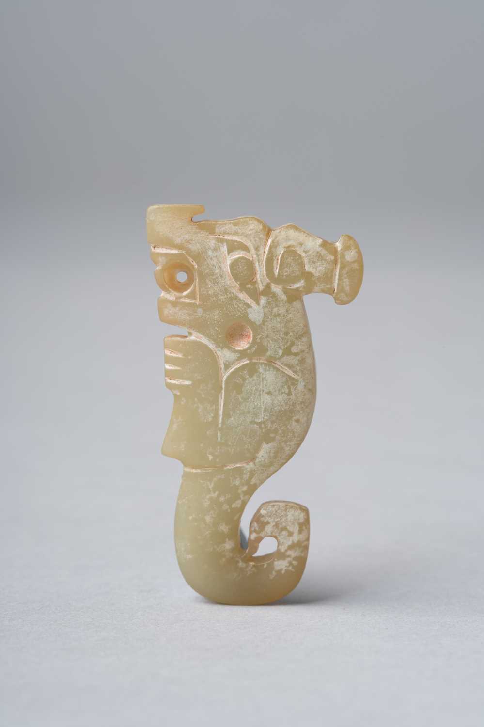 A CHINESE YELLOW JADE 'DRAGON' PENDANT POSSIBLY SHANG DYNASTY Carved as a stylised dragon