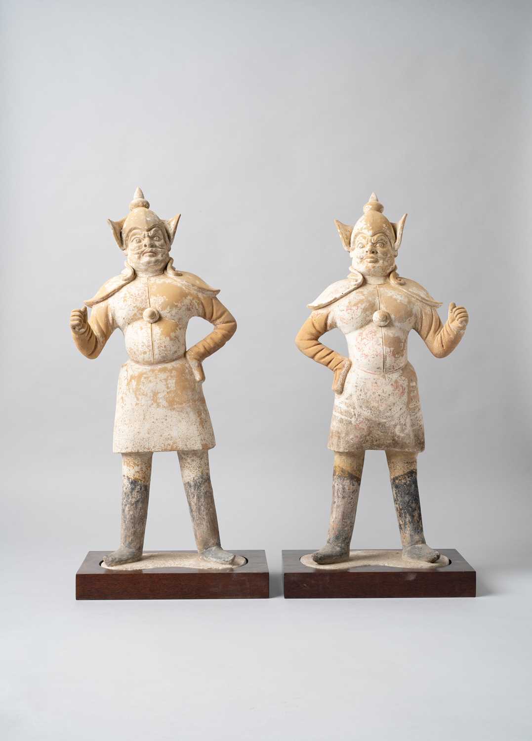 A PAIR OF CHINESE PAINTED POTTERY FIGURES OF GUARDIANS TANG DYNASTY Each depicted standing with
