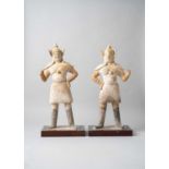 A PAIR OF CHINESE PAINTED POTTERY FIGURES OF GUARDIANS TANG DYNASTY Each depicted standing with