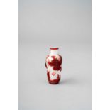 A CHINESE RED OVERLAY GLASS 'DRAGON' SNUFF BOTTLE QIANLONG 1736-95 The tapering milky-white body