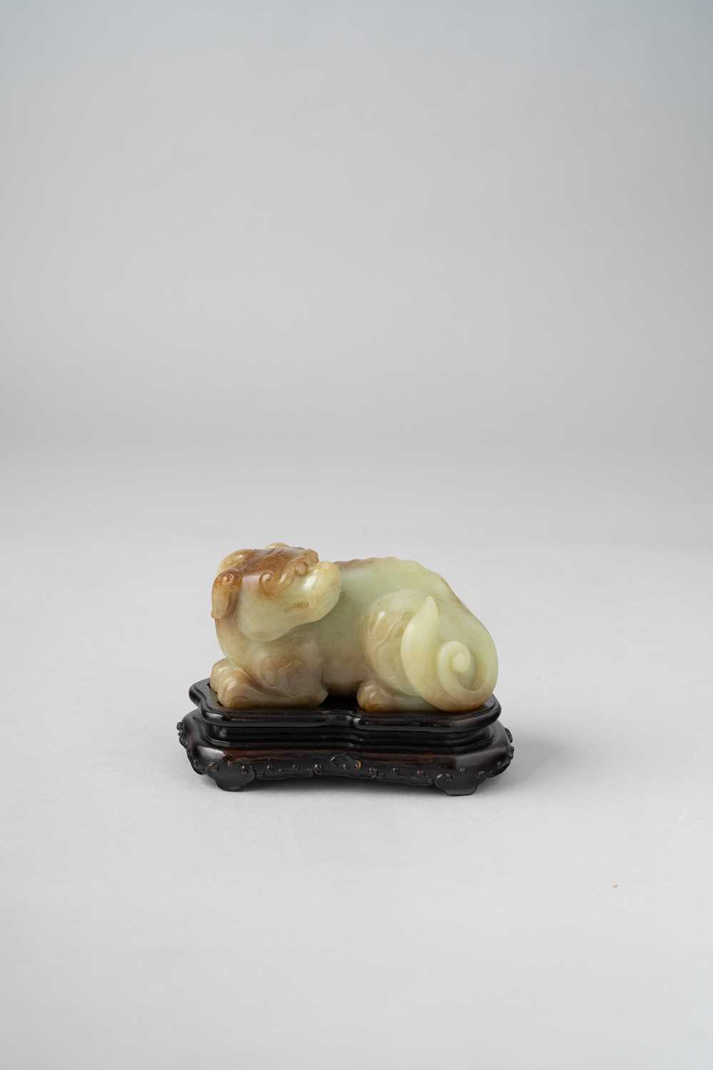 A CHINESE YELLOW AND RUSSET JADE CARVING OF A MYTHICAL BEAST QING DYNASTY The beast depicted